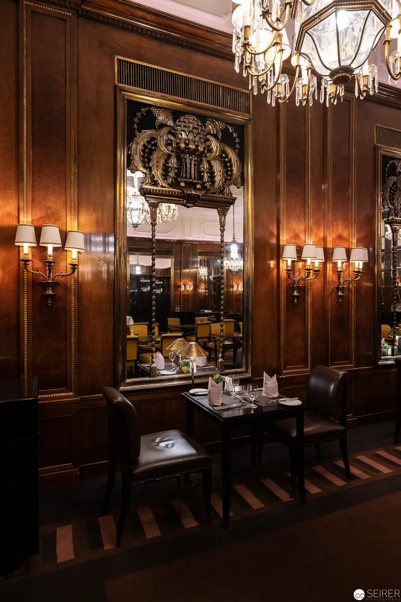 Luxurious Wood-Paneled Dining Room at Hotel Bristol, Vienna with Elegant Chandelier