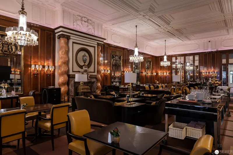 Hotel Bristol Wien: Elegant Interior with Art Deco Chandeliers and Yellow Chairs
