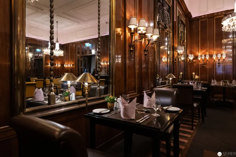 Historic Hotel Bristol Vienna: Elegant Dining Room in Luxurious Wood-Paneled Interior