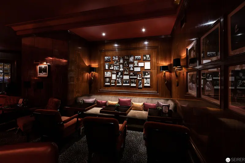 Intimate Wood-Paneled Lounge with Vintage Photographic Gallery Wall