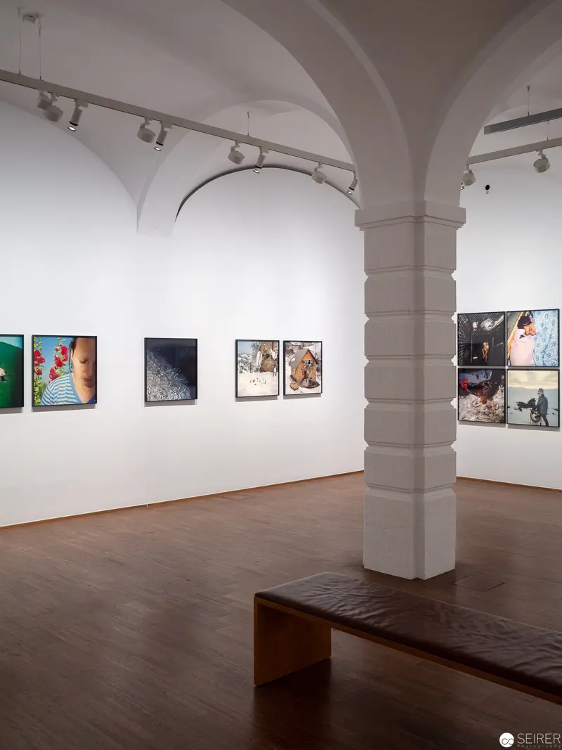 Gallery Interior with Arched Columns and Contemporary Photographic Exhibition