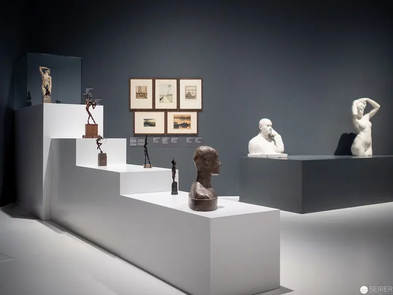 Museum Display of Sculptural Works Arranged on Ascending White Platforms