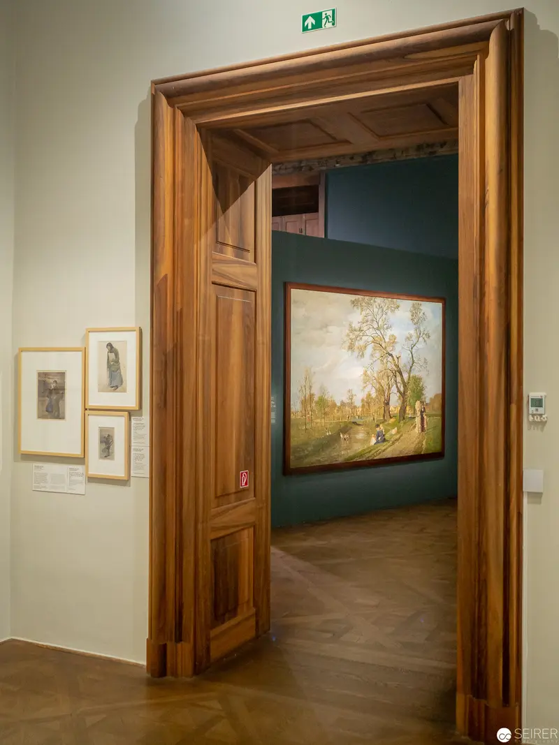 Gallery Interior with Landscape Painting Through Wooden Doorway