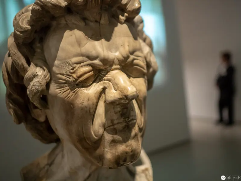 Baroque Marble Bust Expressing Intense Emotional Distortion in Museum Setting