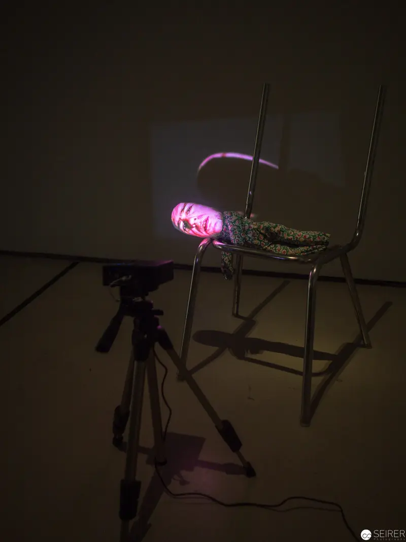 Experimental Photography Setup with Luminescent Pink-Lit Object on Metal Stand