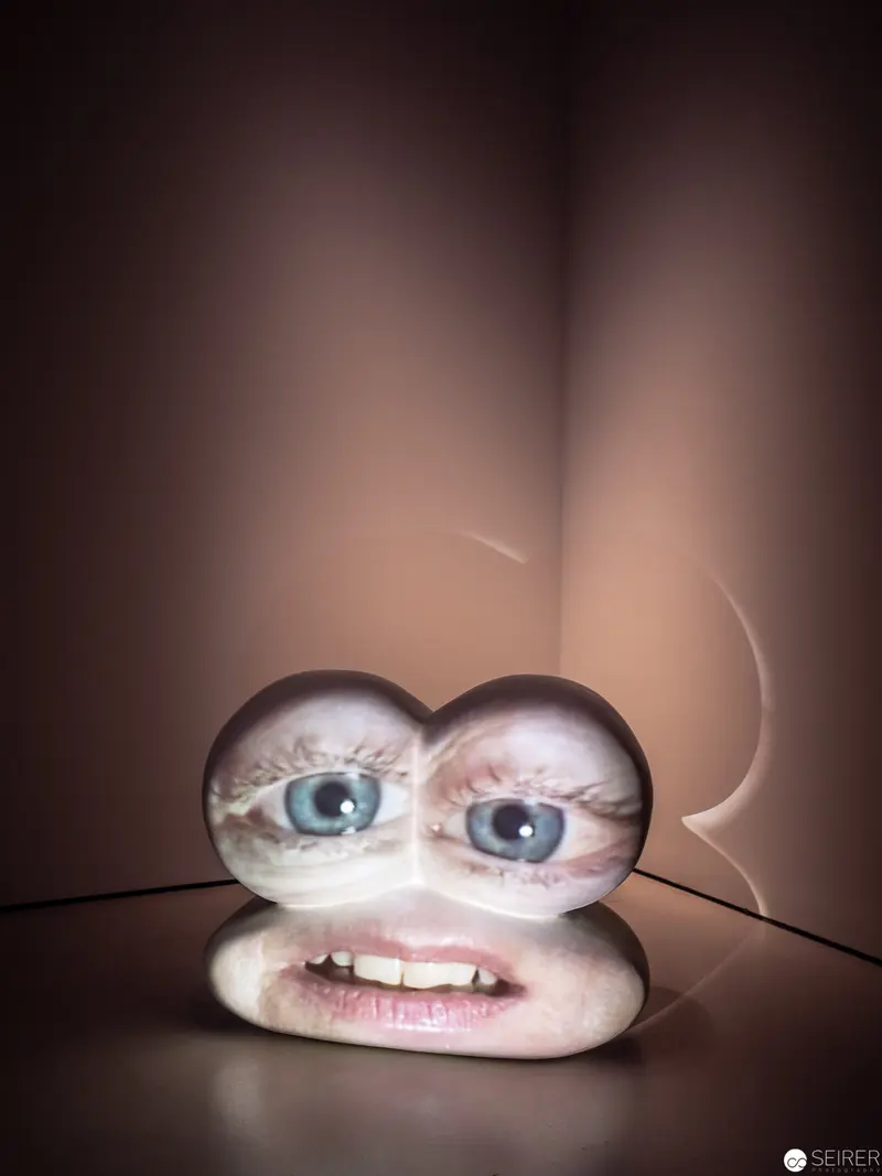 Surreal Sculptural Self-Portrait with Distorted Facial Features and Intense Gaze