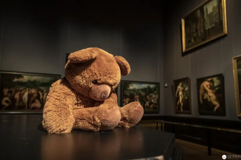 Melancholy Teddy Bear Contemplates Art in Empty Museum Gallery