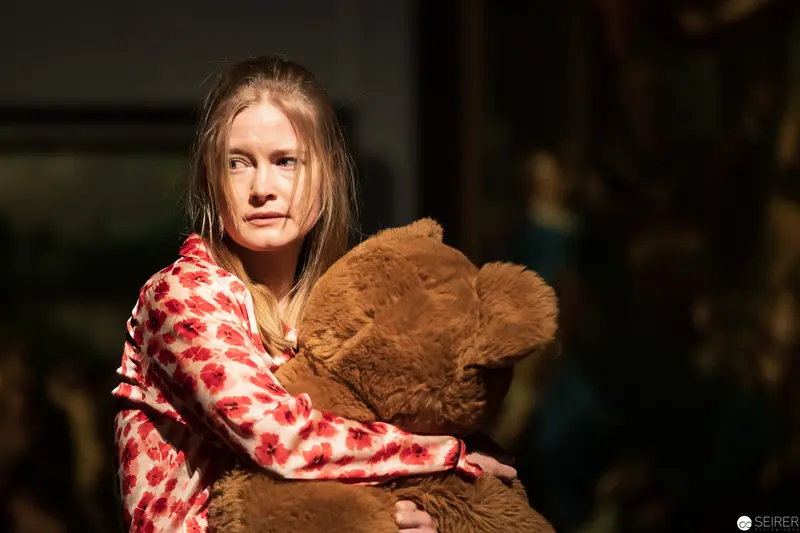 Intimate Portrait of Contemplative Woman Embracing Large Plush Teddy Bear