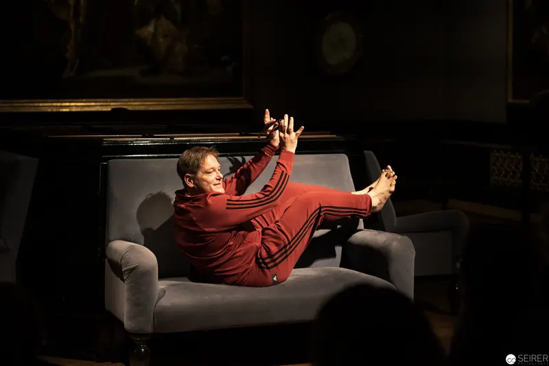 Performer in Red Seated in Dynamic Pose during Ganymed In Love 2019 Performance