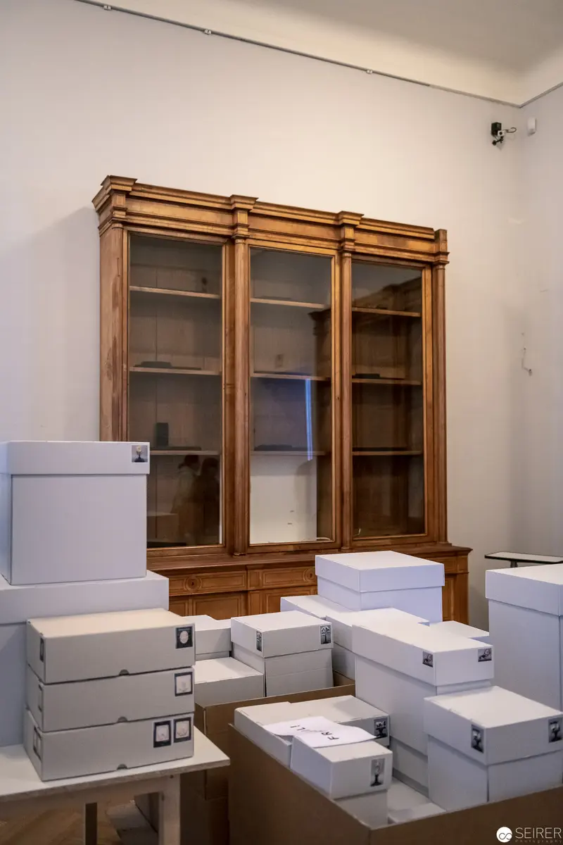 Archival Storage Room with Vintage Wooden Cabinet and White Document Boxes