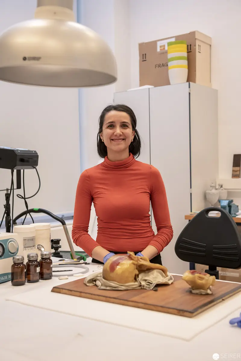 Woman in Coral Sweater Preparing Food in Research or Culinary Laboratory Setting