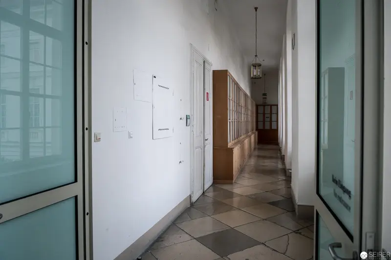 Institutional Corridor with Tiled Flooring and Glass Partition Doors