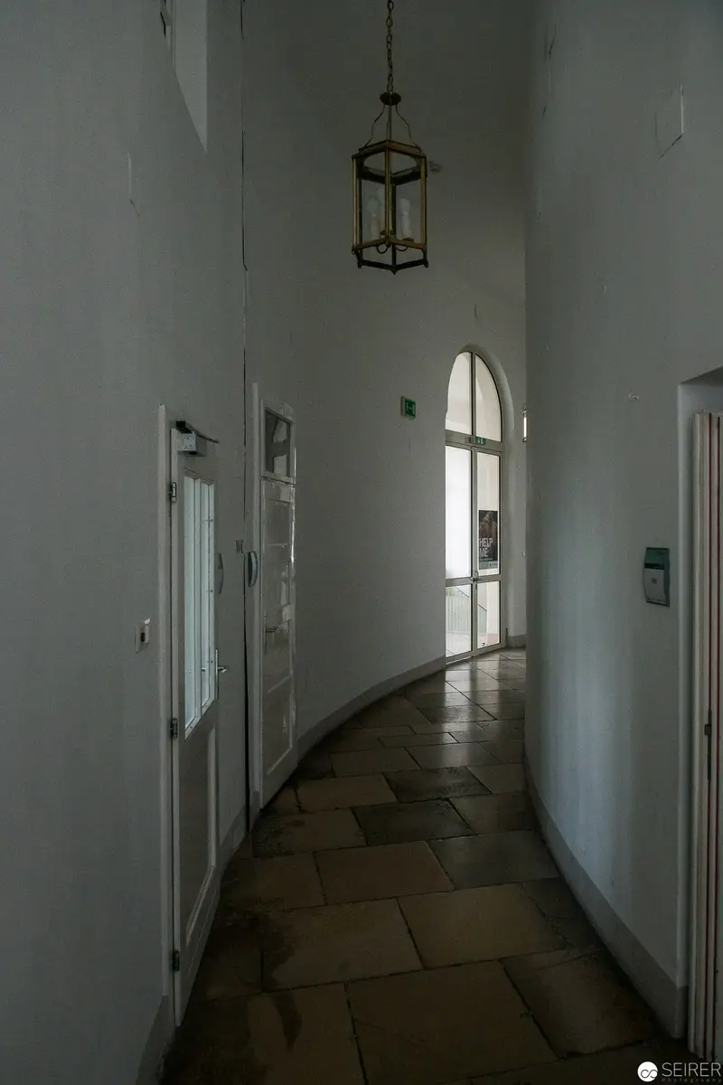 Arched Window and Curved Corridor in Minimalist Architectural Interior