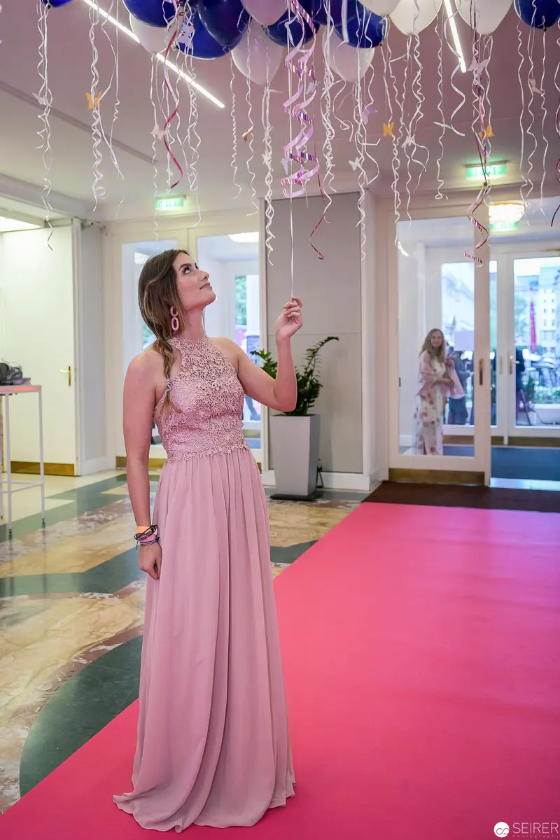 Pink Gown and Blue Balloons: Elegant Event Atmosphere in Formal Interior
