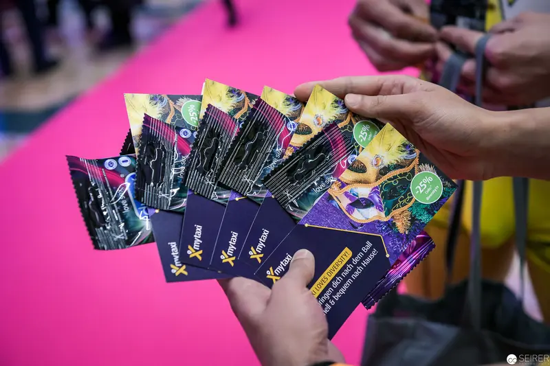 Promotional Materials Fanned Out on Vibrant Pink Background at Event
