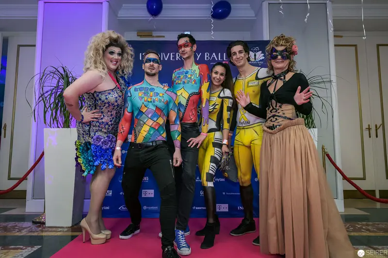 University Pride Ball: Six Costumed Performers on Vibrant Themed Photographic Backdrop