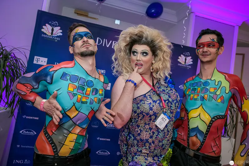 Pride Event Participants in Colorful Costumes Posing at LGBTQ+ Celebration