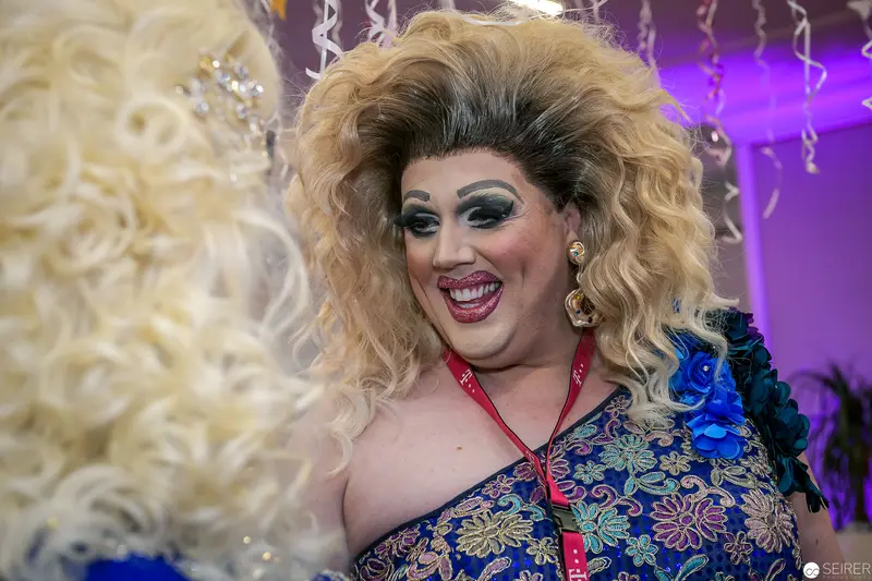Flamboyant Drag Performer in Vibrant Brocade Costume at Performance Event
