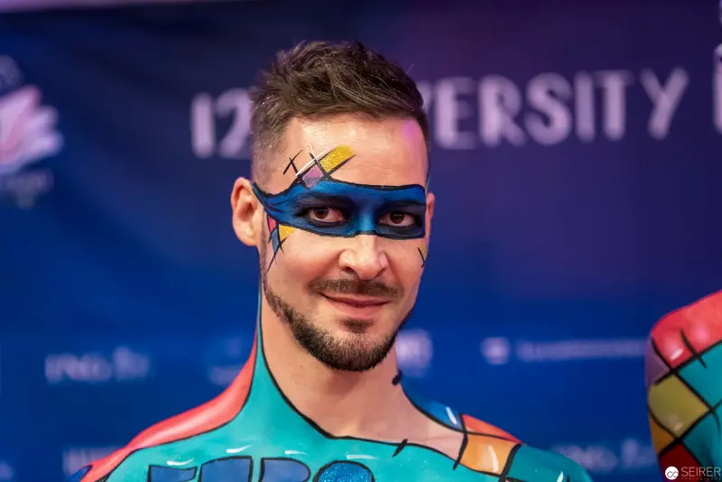 Athlete in Colorful Body Paint with Geometric Face Mask at Diversity Event