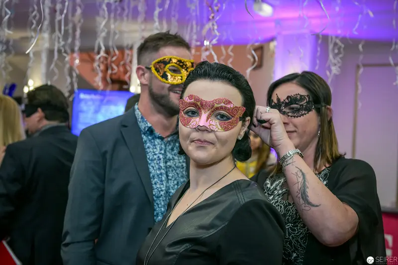Masked Attendees at Masquerade Event with Ornate Venetian-Style Carnival Masks