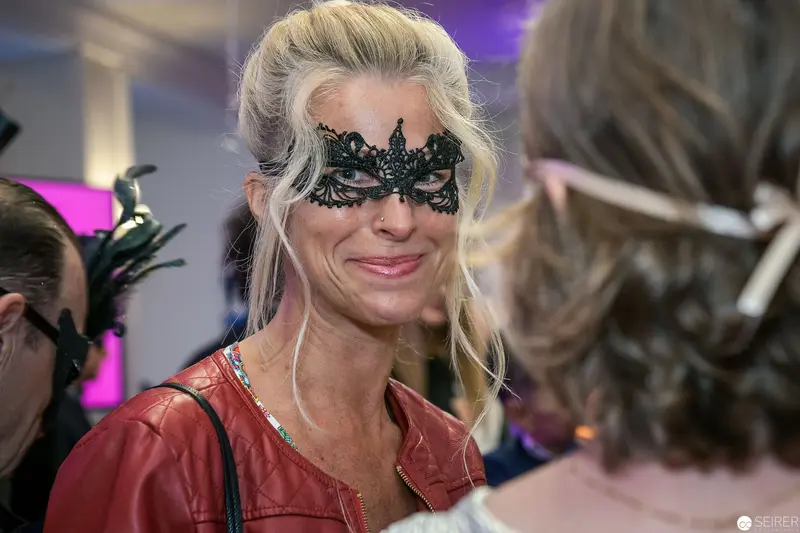 Blonde Woman in Ornate Lace Mask at Masquerade Event
