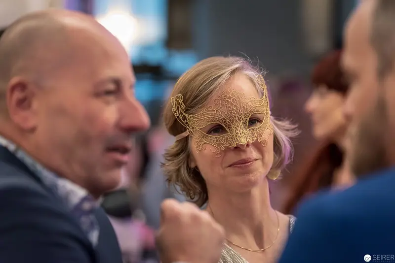 Venetian Masquerade: Intricate Golden Mask at Social Gathering