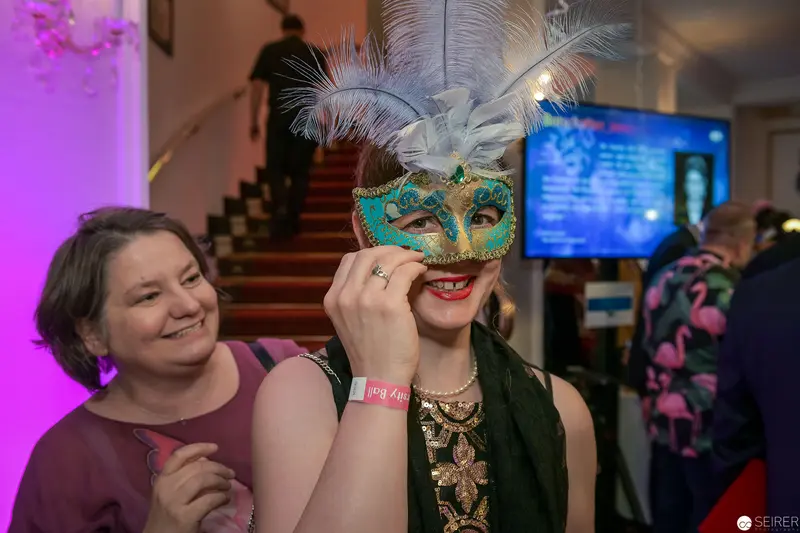 Masquerade Event: Woman in Turquoise Venetian Mask with Companion