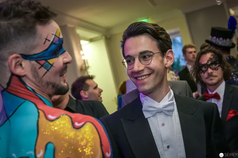 Masked Guests at Elegant Costume Gala: Theatrical Interactions in Formal Attire