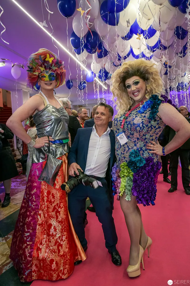 Festive Performance: Drag Artists in Elaborate Costumes at Celebratory Event