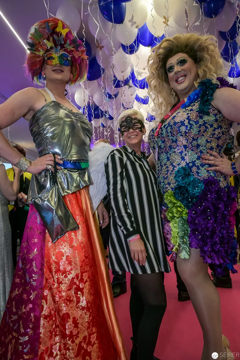 Drag Performers Posing Amid Blue and White Balloons at Festive Event