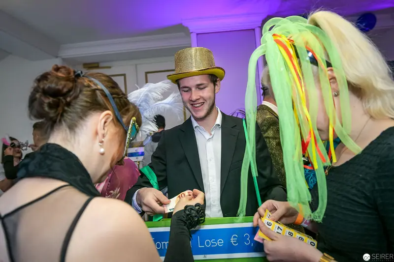 Party Game Participants in Golden Hat and Colorful Accessories