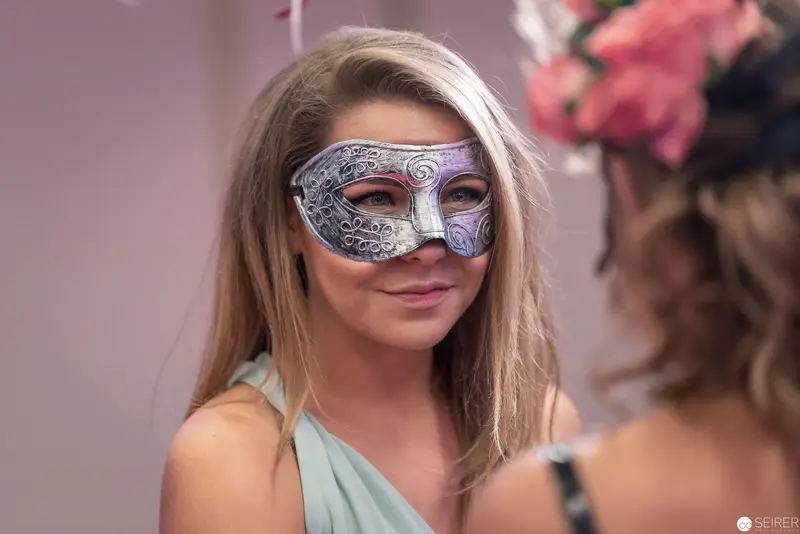 Masked Woman in Pale Green at Masquerade Event