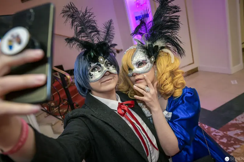 Masked Duo in Cosplay: Selfie with Theatrical Feathered Masks