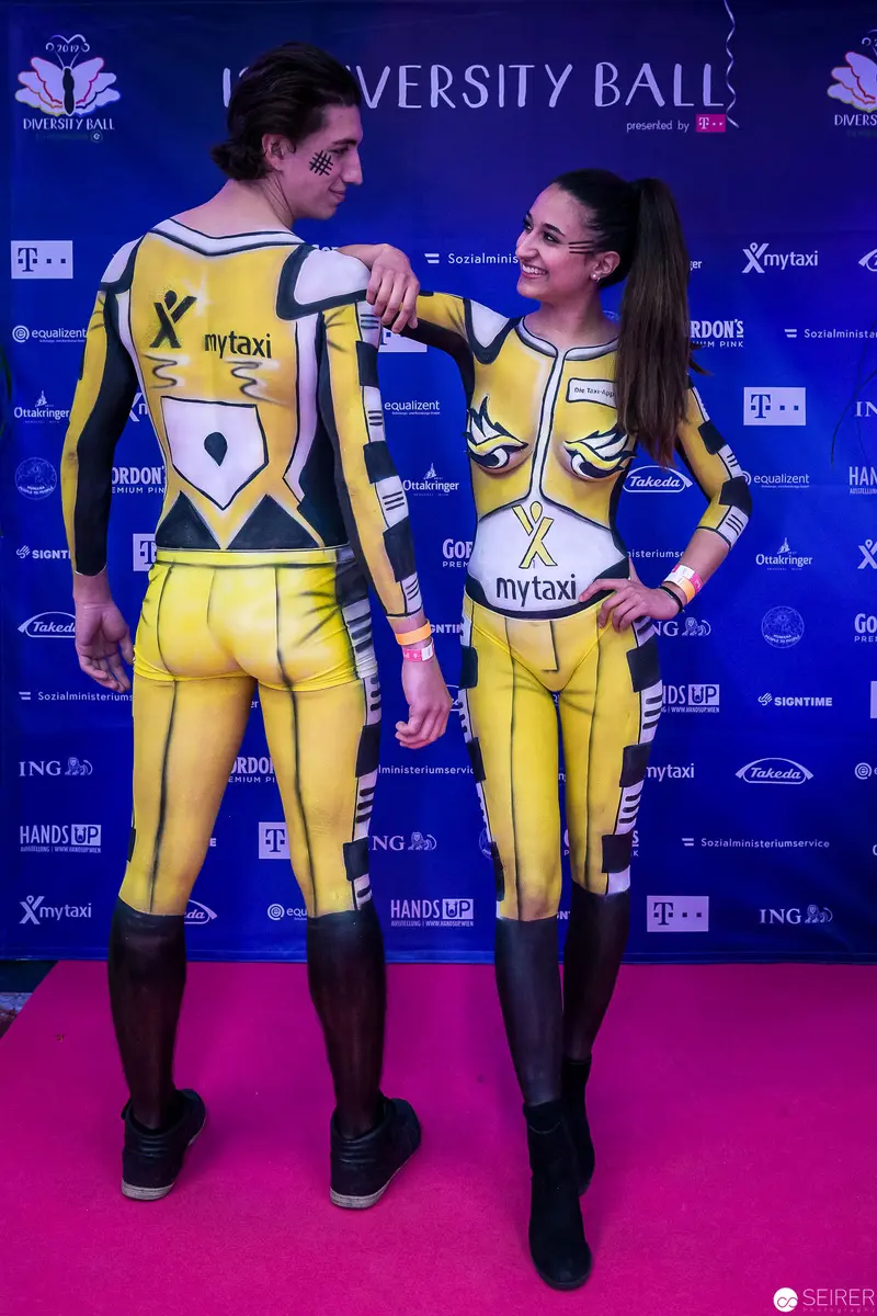 Two Performers in Yellow Promotional Uniforms at University Ball Event