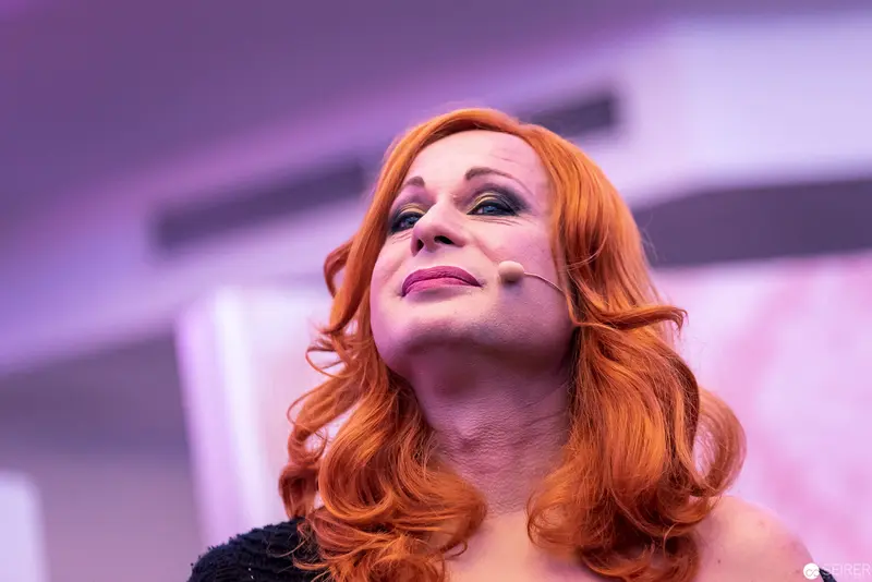 Performative Portrait of Redheaded Drag Artist in Theatrical Lighting