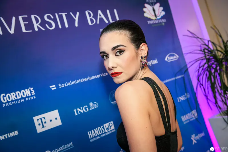 Woman in Black at University Ball Red Carpet Event with Corporate Sponsors