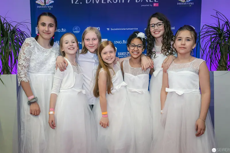 Young Performers in White Dresses at 12th Diversity Ball Event