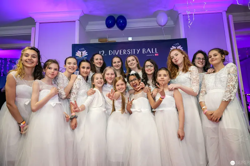 Participants in White at 12th Annual Diversity Ball Commemoration