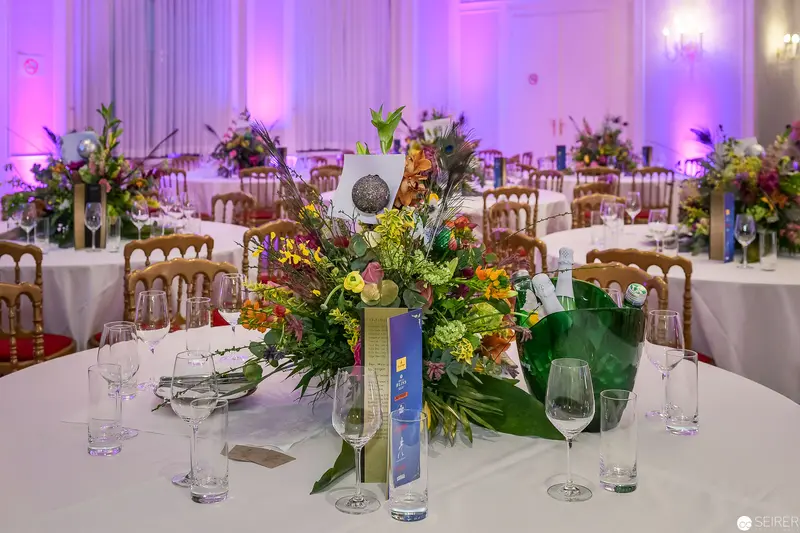 Elaborate Floral Centerpiece at Formal Event with Purple Ambient Lighting