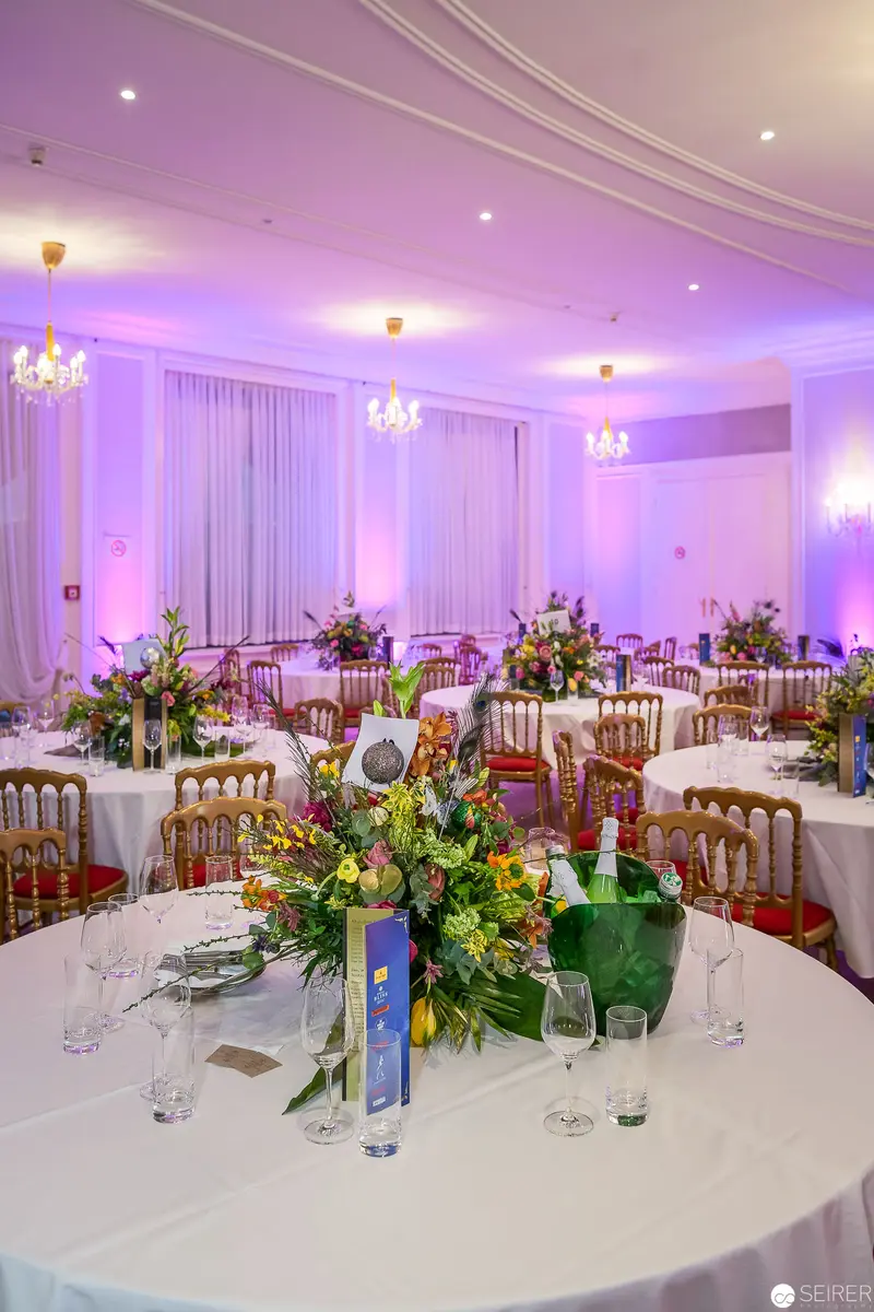 Elegant Wedding Reception with Lavender Lighting and Floral Table Centerpieces