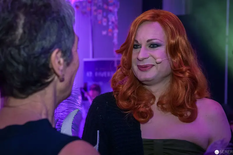 Smiling Redhead in Purple and Green Nightclub Lighting