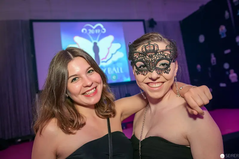 Masquerade Ball Event: Two Young Women in Elegant Evening Attire