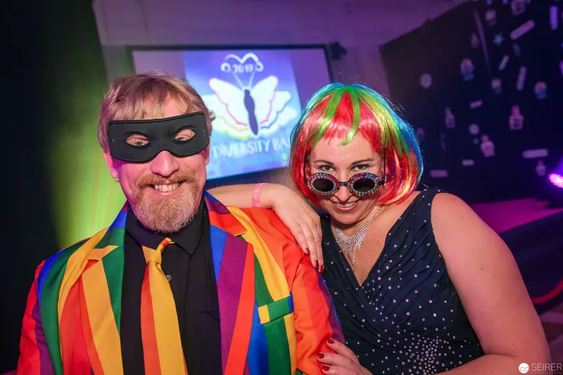 Rainbow Pride Masked Duo at University Event in Vibrant Festive Attire