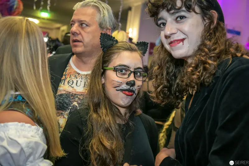 Halloween Party Attendees in Playful Cat-Themed Costume Makeup