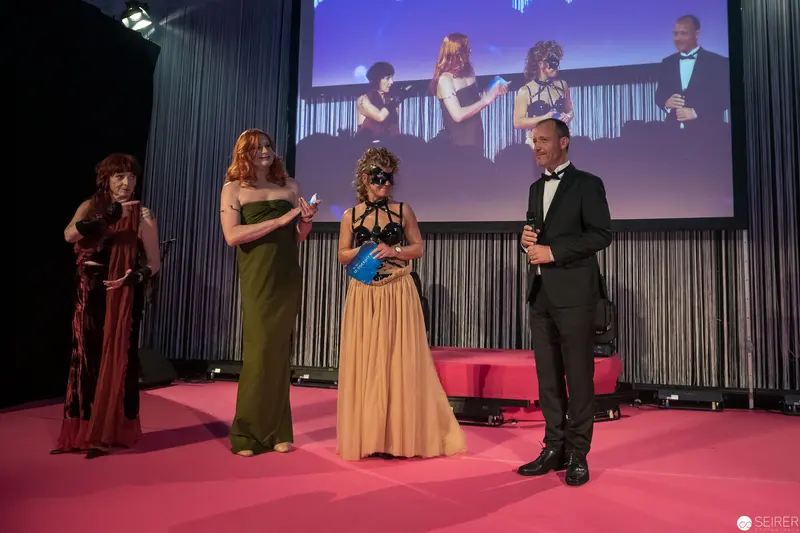 Award Ceremony Stage Performance with Elegantly Dressed Presenters in Formal Attire