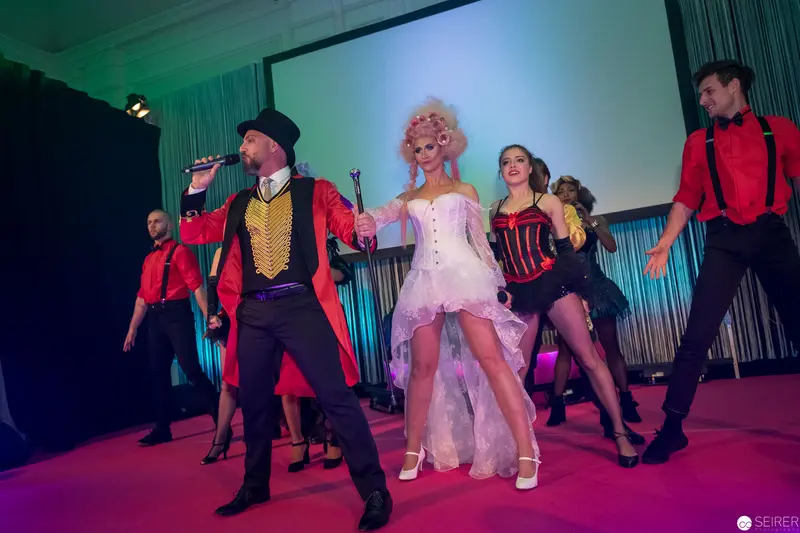 Theatrical Performance with Ringmaster and Ensemble in Stylized Costumes
