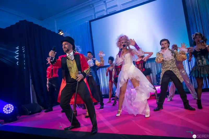 Theatrical Performance with Ringmaster and Ensemble in Vibrant Stage Choreography