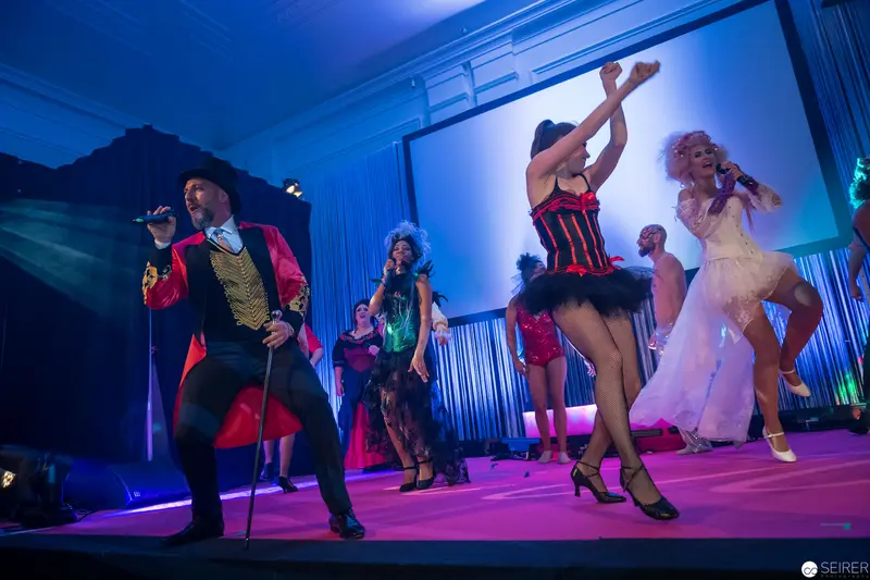 Theatrical Cabaret Performance with Vibrant Performers in Dynamic Stage Lighting