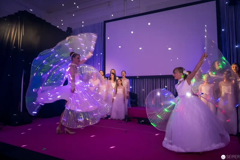 Luminescent Performance with Glowing Dancers in White Ethereal Costumes