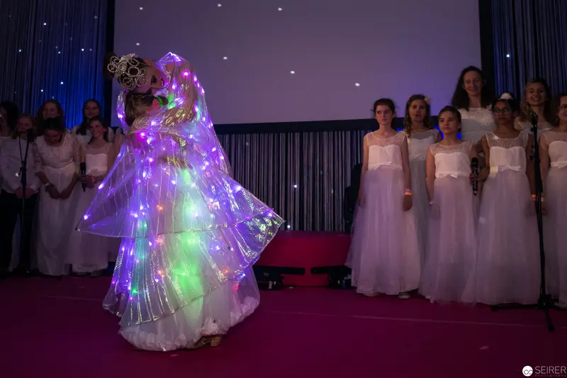 Luminescent Performance with Illuminated Dress and White-Robed Ensemble